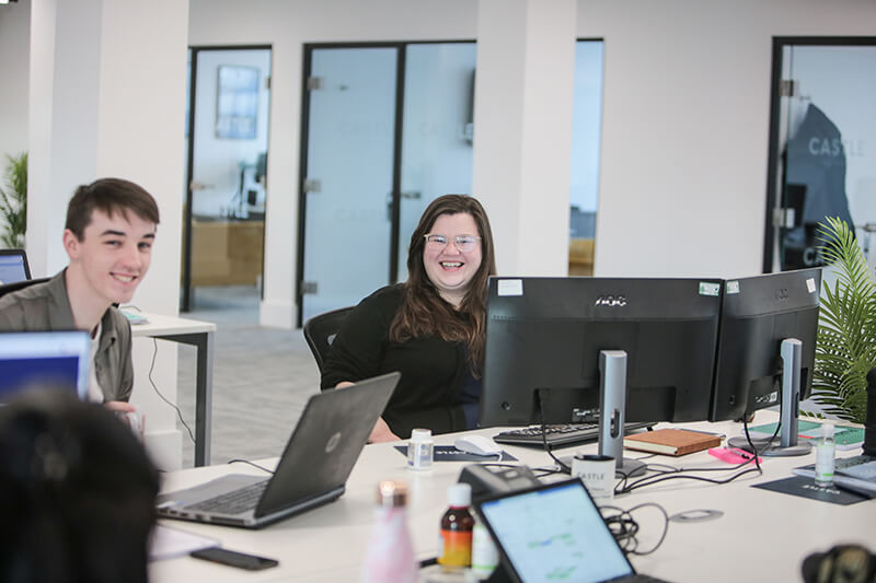 Castle team members working together in the Liverpool office