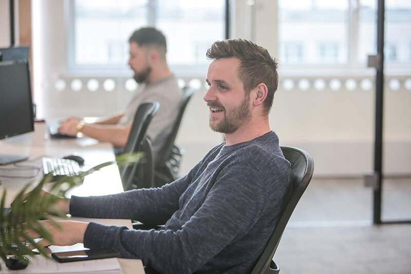 A Castle marketing specialist at his desk